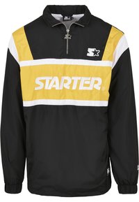 Jachetă neagră tip windbreaker cu fermoar până la jumătate, având dungi orizontale albastre și albe și un mare logo "STARTER" pe piept. Manșete elastice.