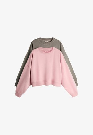 Two crewneck sweatshirts, one pink and one gray, laid flat with the pink sweatshirt in front overlapping the gray one.