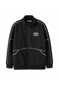 Veste noire zippée avec passepoil jaune le long des manches et des poches, avec le logo "Urban Uniform" sur la poitrine gauche.