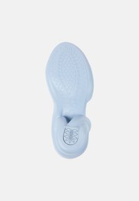 Light blue rubber sole featuring a patterned grip surface with a leaf motif, contoured design, and smooth texture. Size marked inside.
