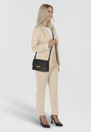 ALEX UMHÄ - Cross body bag - black