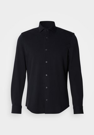Black long-sleeve shirt made of smooth fabric, featuring a collared neck, front button closure, and tailored fit with rounded hem.