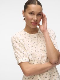 Floral dress with light beige base, featuring blue and yellow flowers. Short puff sleeves, round neckline, and soft textured fabric.