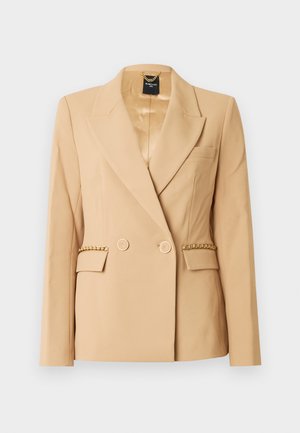 Bēša divrindu žakete ar zelta toņa detaļām, iegriezuma formas atloku un sānu kabatām. Gluda tekstūra ar ķēdes akcentu uz kabatu vāciņiem.