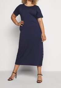 Navy blue maxi dress made from smooth fabric, featuring a round neck, short sleeves, and button detailing along the side.