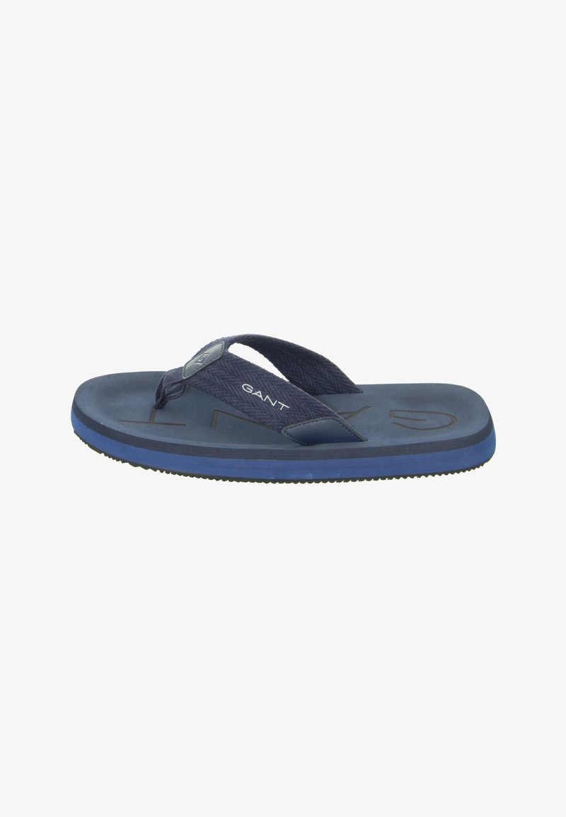 Navy flip-flop with a textured fabric strap, flat sole, and a rubberized blue bottom. Features embossed logo on the footbed.