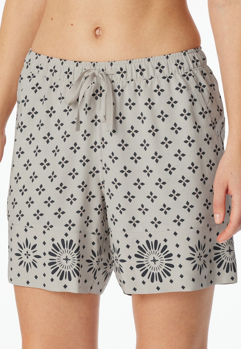 Shorts de bain gris avec un motif floral en bleu marine, dotés d'une taille élastique et d'un cordon de serrage, le tout en tissu lisse et léger.