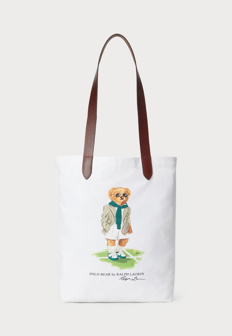Canvas tote bag featuring a cartoon bear in a green scarf and blazer, with brown leather shoulder straps. White background, printed design.