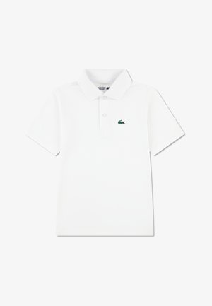 Polo blanc en coton, doté d'un col classique et d'une patte de boutonnage à trois boutons. Comprend un petit logo crocodile vert sur la poitrine.