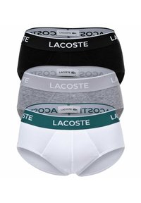 Ensemble de sous-vêtements pour hommes Lacoste en trois couleurs : noir, gris et blanc. Chacun dispose d'une ceinture élastique avec logo et d'un tissu en coton pour le confort.