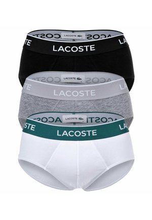 Lacoste Herren Slip Unterwäsche Set in drei Farben: Schwarz, Grau und Weiß. Jedes hat einen elastischen Bund mit Logo und besteht aus Baumwollstoff für zusätzlichen Komfort.