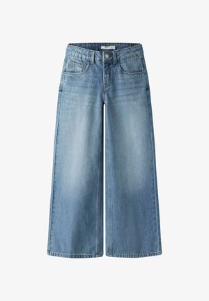 Lyseblå vidbukse i denim med høy midje, fire lommer og knappelukking. Lett falmet tekstur med rene kanter.