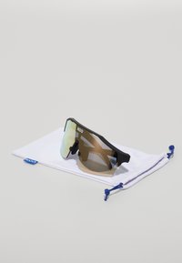Sport sunglasses with a black frame and brown-tinted lens, featuring a mirrored finish. Includes a white protective pouch with blue accents.
