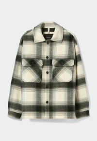 Chaqueta de camisa de cuadros en negro, blanco y gris. Hecha de un tejido suave con cierre de botones en la parte delantera, cuello puntiagudo y dos bolsillos en el pecho.