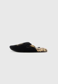 Pantuflas de terciopelo negro con un diseño bordado en la parte superior, con la parte trasera abierta y un forro de leopardo. Suela plana y forma de punta.