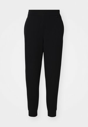 Sorte joggebukser laget av mykt stoff, med smalere ben, elastisk livlinning og ribbede mansjetter med sidesømmer for et skreddersydd utseende.