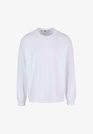 Fehér, hosszú ujjú póló, amely kerek nyakkivágással, laza szabással és rugalmas mandzsettákkal rendelkezik. Puha, sima pamutszövetből készült.