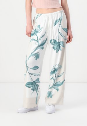 Wide-leg pants in lightweight fabric, featuring a floral print in teal on a white background. Elastic waistband with a drawstring detail.