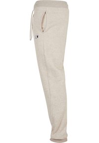 Lichtbeige sweatpants van zachte stof, met een elastische tailleband met trekkoord, zijzakken en geribbelde boorden.