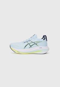 Light blue athletic shoe with a textured upper, reinforced sides, white midsole, and a bright yellow-green accent on the outsole.