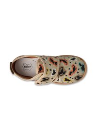 Beżowy but z wielokolorowymi wzorami zwierząt, z miękką tkaniną na cholewce, regulowanym paskiem na rzep oraz jasnobrązową gumową podeszwą.