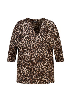 Blouse à manches longues imprimé léopard avec un col en V et une coupe décontractée, présentant des taches marron, noires et beiges dans un motif animalier.