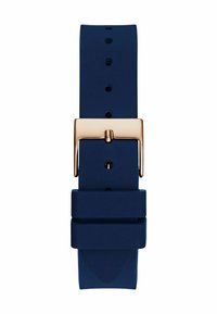 Tumesine silikoonist kellarihm kuldse värviga metallist klambriga, millel on mitu reguleerimisavat ja sile, mati tekstuur.