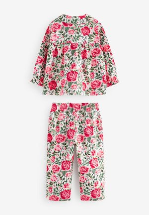 Completo floreale composto da una maglietta a maniche lunghe e pantaloni con vita elasticizzata. Il materiale presenta rose rosa e foglie verdi su uno sfondo bianco.