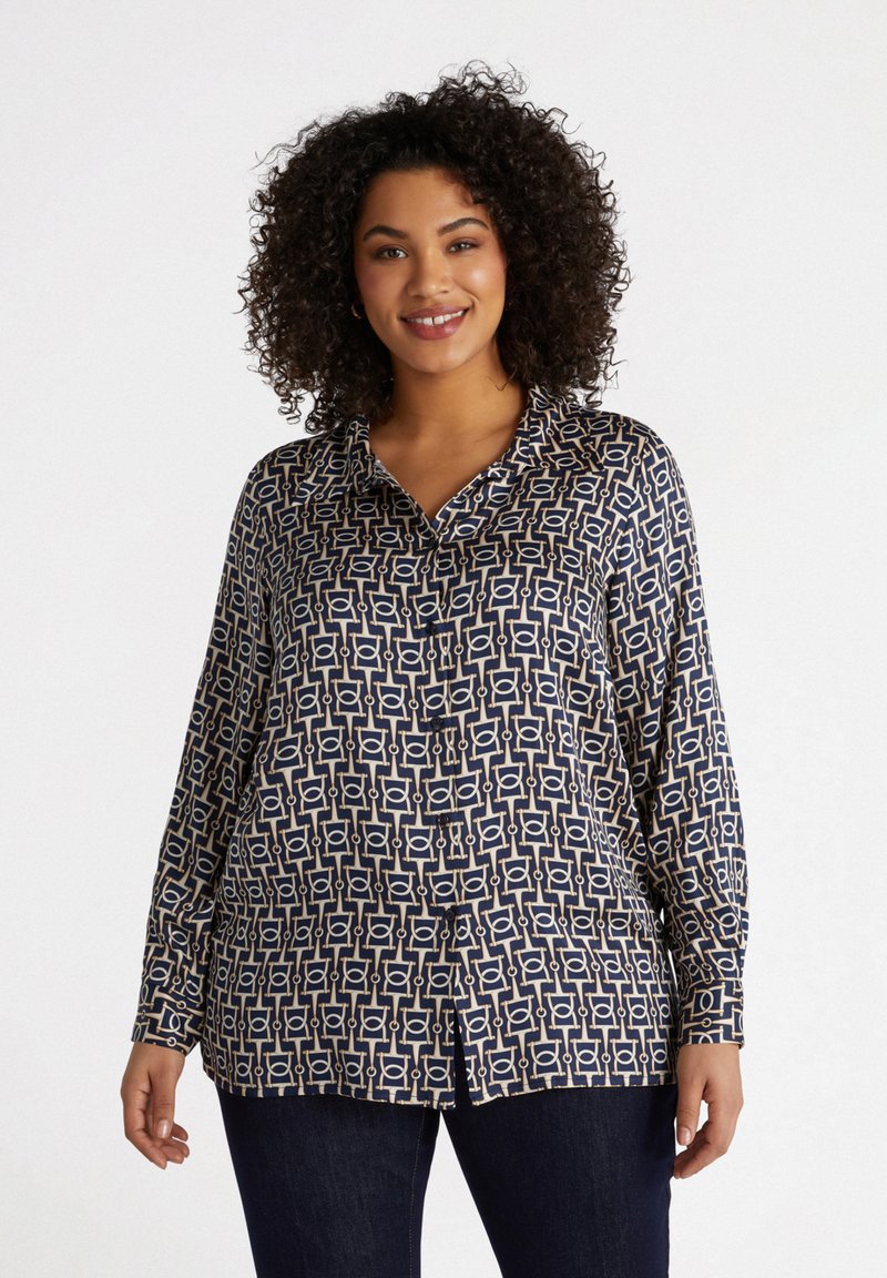 Blusa de color navy con patrón geométrico en crema y oro. Mangas largas, cuello, cierre de botones en la parte delantera, tejido ligero. Llega a las caderas, corte relajado.