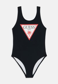 Fekete egyrészes fürdőruha kerek nyakkivágással, piros és fehér háromszög alakú logóval, amely pálmafát és a "GUESS BEACH" feliratot tartalmazza az elülső részen.