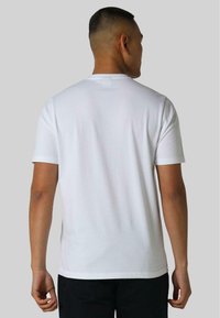 White cotton t-shirt with short sleeves, a round neckline, and a simple design, viewed from the back with a smooth texture.