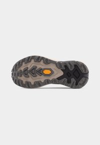 Σόλα πεζοπορικού παπουτσιού με βαθιές ανάγλυφες αυλακώσεις, γκρι και μαύρο καουτσούκ, και πορτοκαλί λογότυπο Vibram στο κέντρο.