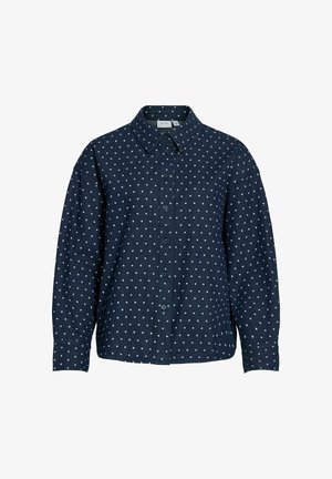 Navy blue button-up shirt with white polka dots, featuring a pointed collar, long sleeves, and a relaxed fit. Soft, textured fabric.