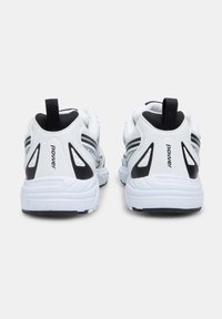 White athletic shoes with a textured upper, black accents, and grey stripes. Features a padded heel and pull tab for easy wear.