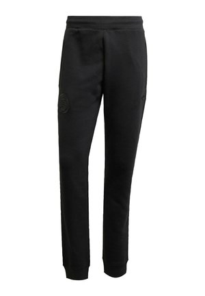 Pantalones de chándal negros de tejido suave, con un diseño ajustado, cinturilla elástica y un parche de logo texturizado en el muslo izquierdo.