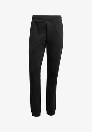 Pantaloni sportivi neri realizzati in tessuto morbido, con un design affusolato, vita elastica e un'etichetta logo testurizzata sulla coscia sinistra.