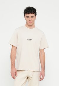 Beige cotton t-shirt with short sleeves and crew neck, featuring a small printed logo on the chest. Smooth texture, relaxed fit.