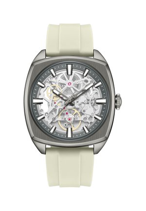 Firkantet sølvfarvet ur med gennemsigtigt urskive, der viser tandhjul, hvide timeindikatorer, grå visere og en hvid silikonerem.