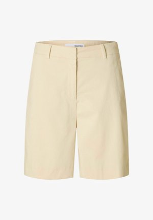 Bézs színű pamut rövidnadrág egyenes szabással, elöl cipzárral és két oldalzsebbel. Simább tapintású, letisztult dizájn elemekkel.