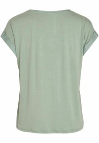 T-shirt vert clair avec des manches courtes retroussées et une coupe décontractée. Matière en coton lisse, vue de dos montrant un design simple et des détails de couture.