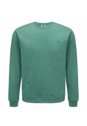 Lichtgroen sweatshirt met een ronde halslijn, versierd met geborduurde glimlachen, harten en vredessymbolen in verschillende kleuren. Zachte textuur.