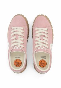 Pink suede sneakers with white logo, cream laces, and gum rubber outsole. Textured red and white checkered accents on the heel.