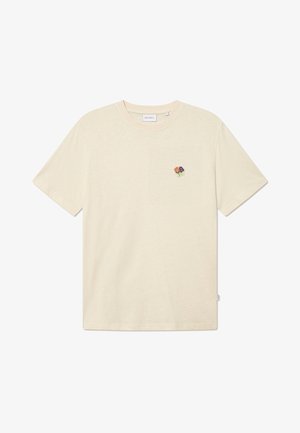 Krém színű, pamut póló rövid ujjal és kerek nyakkivágással. Az oldalán hímzett virágmintával rendelkezik, ami a bal mellen található.