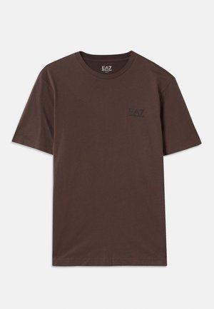 Brown cotton t-shirt with short sleeves and a round neckline. Features a small black logo on the chest. Smooth texture and simple design.