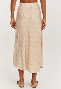 Beige midi sukňa so vzorom na námornú tému v svetlohnedej farbe. Ľahká tkanina, elastický pás, splývavý dizajn a mierne zakrivený lem.