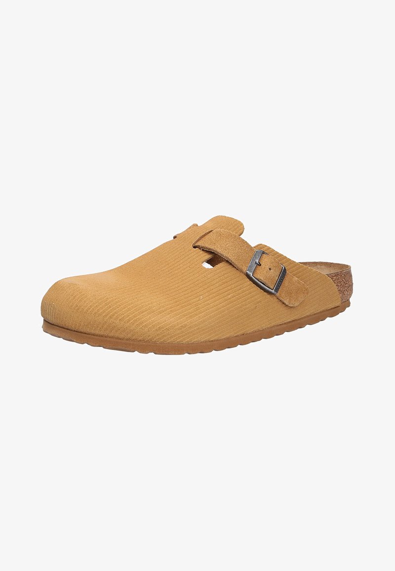 Tan suede slip-on clog with a ribbed texture, adjustable buckle strap, and a cork footbed. Rounded toe and flexible rubber sole.
