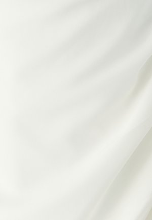 Smooth white fabric with soft folds and gentle shadows, highlighting its texture and light draping effect.