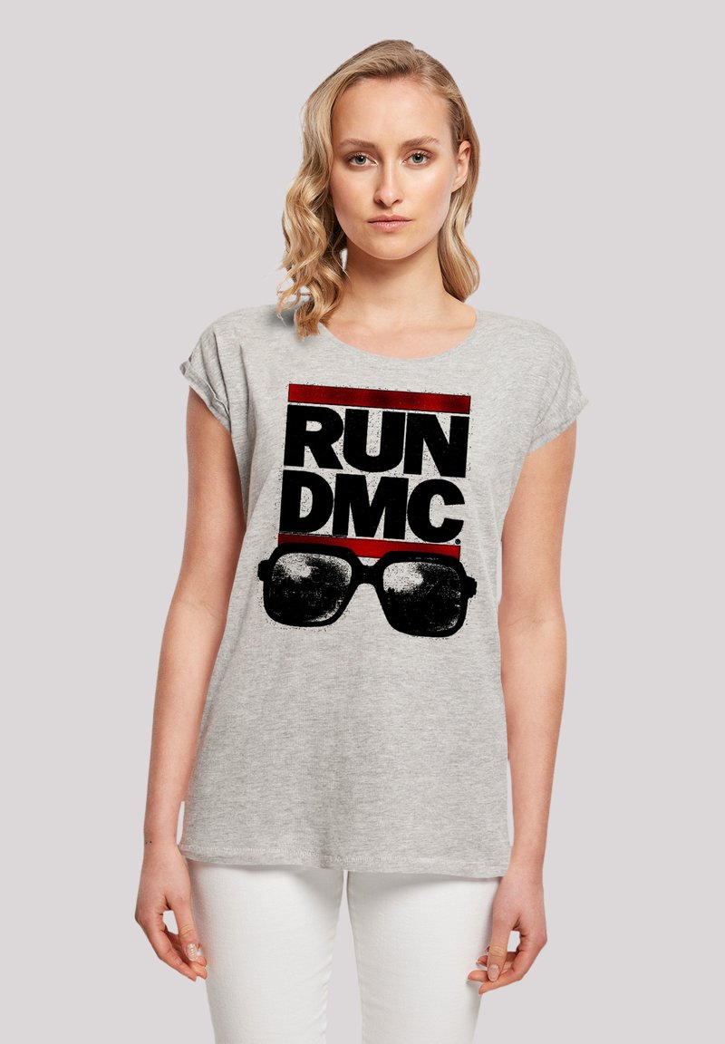 Gray cotton T-shirt with rolled sleeves, featuring a bold black and red "RUN DMC" graphic and sunglasses print in the center.