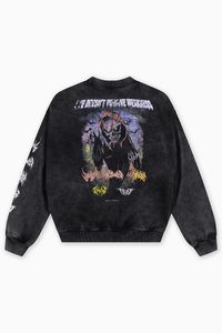 Black sweatshirt featuring a graphic of a skull with horns on the back, various text designs in white and vibrant colors, ribbed cuffs and hem.