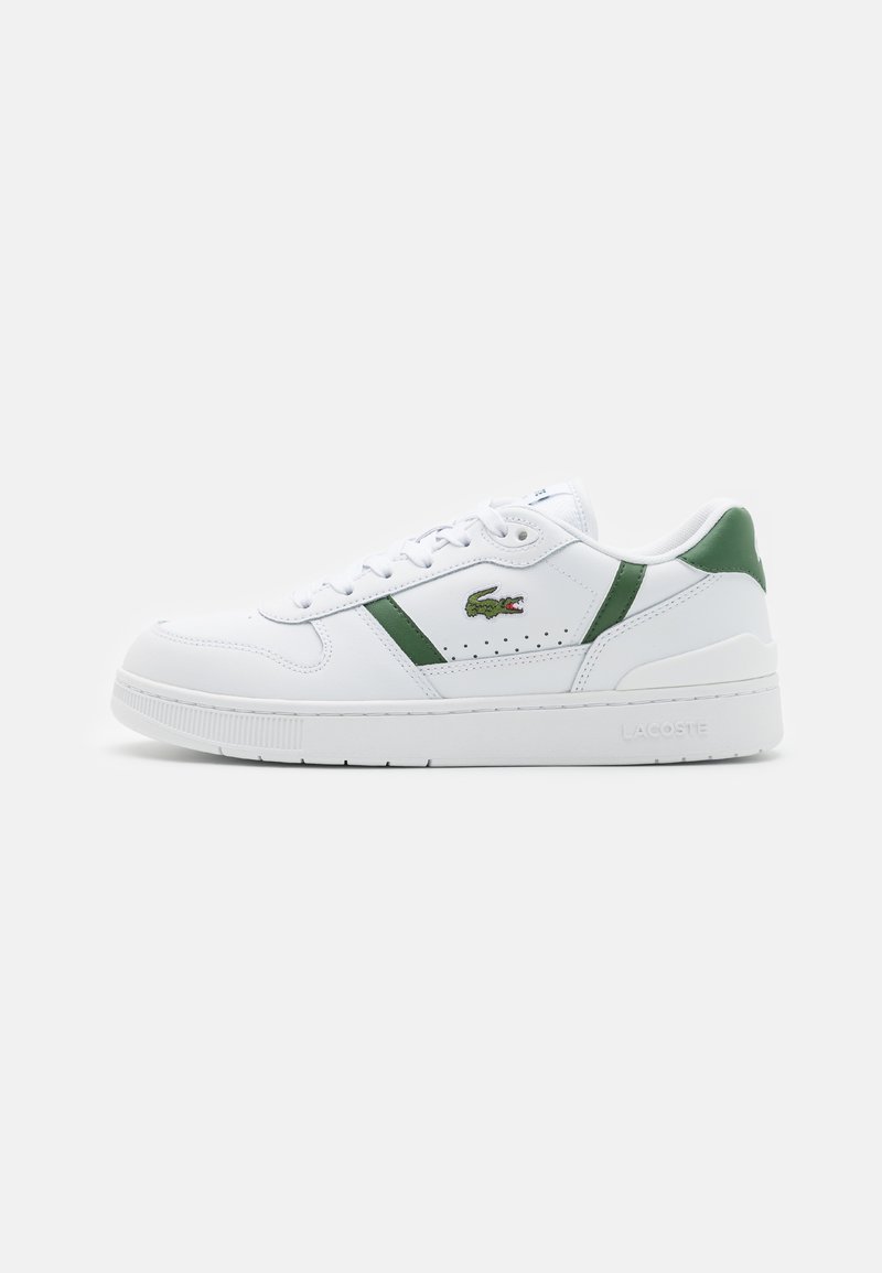 White leather sneakers with green accents, perforated detailing, and a logo on the side. Features a textured sole and a padded collar.
